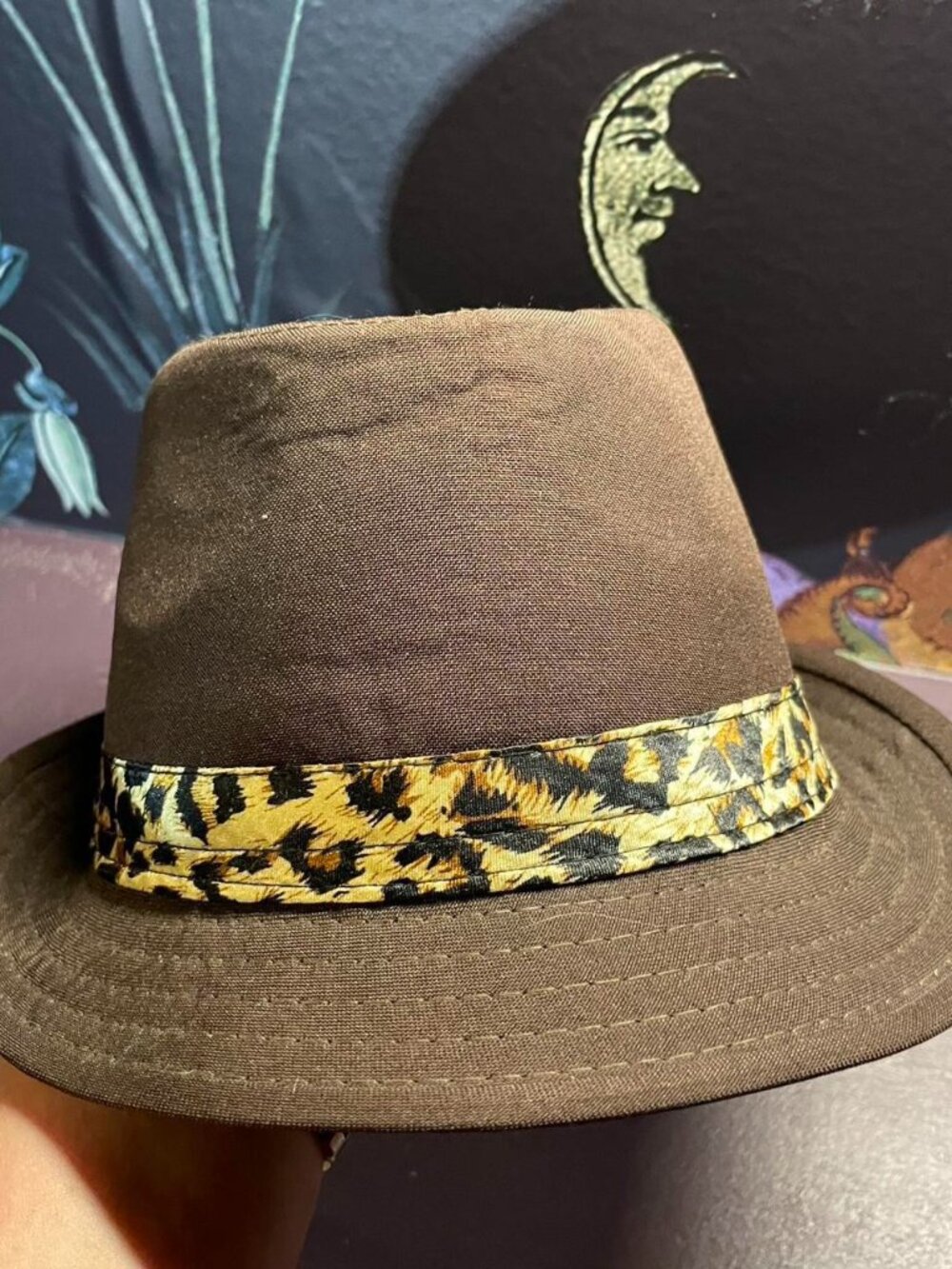 Brown fedora with cheetah print hat band